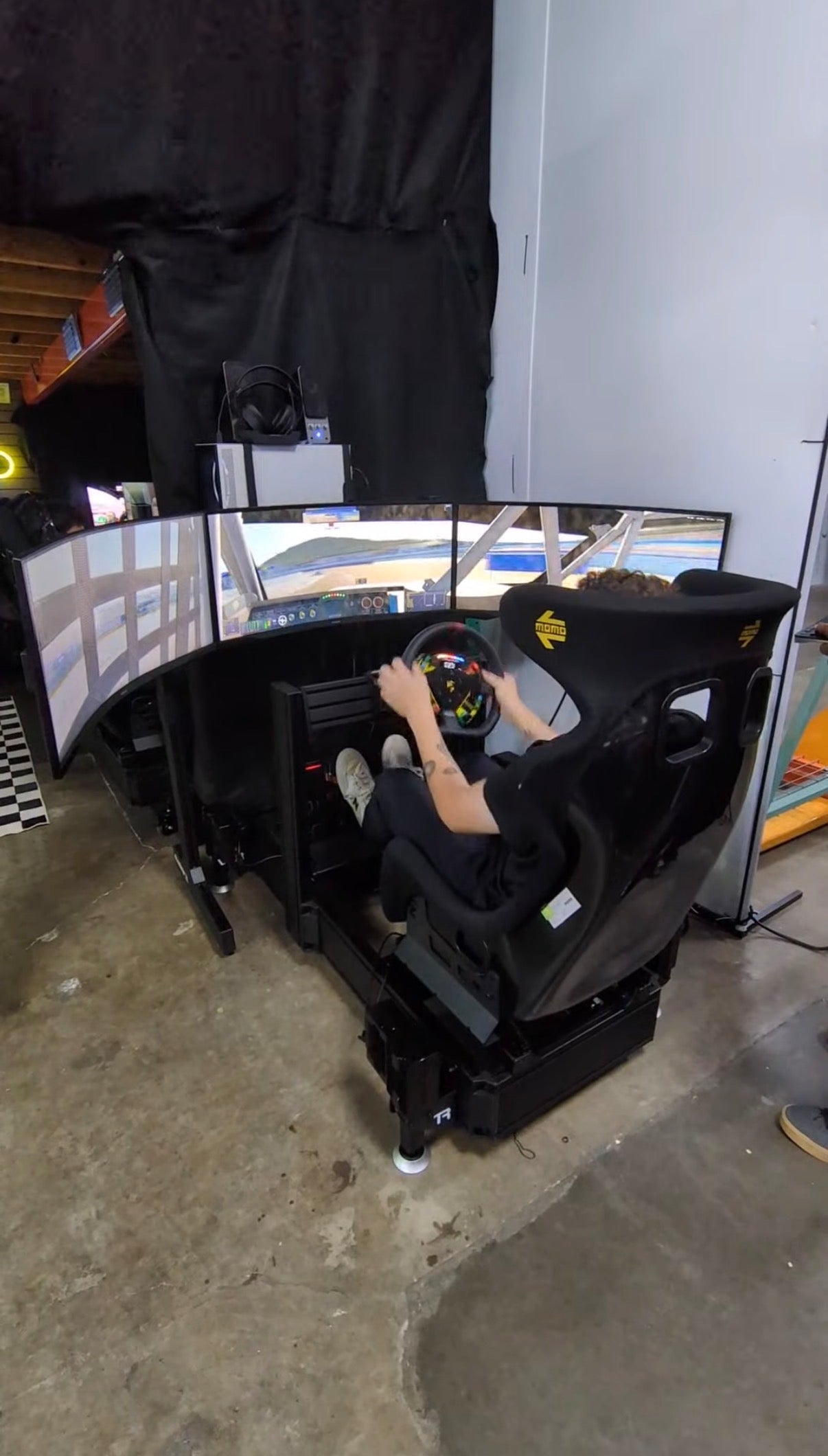 An Academy simulator rig set up in a darkened expo booth