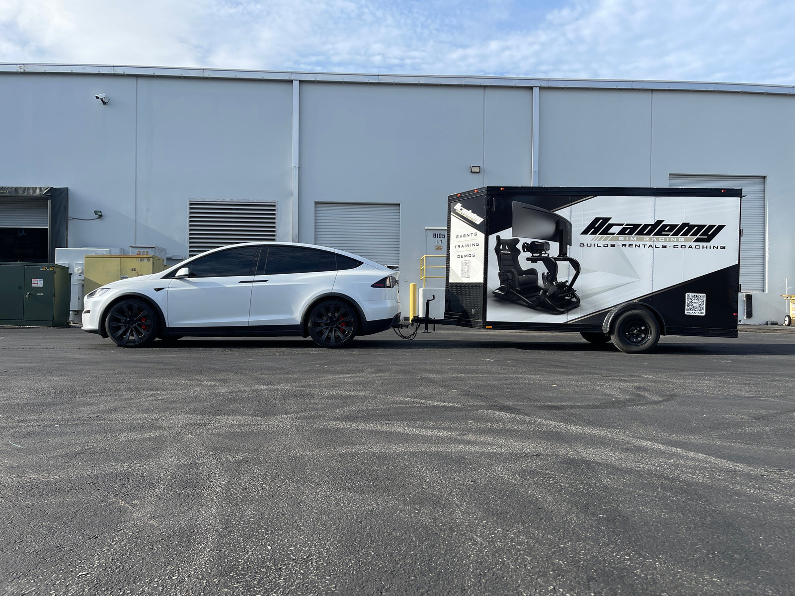 The branded Academy Sim Racing event trailer used for simulator activations across Florida