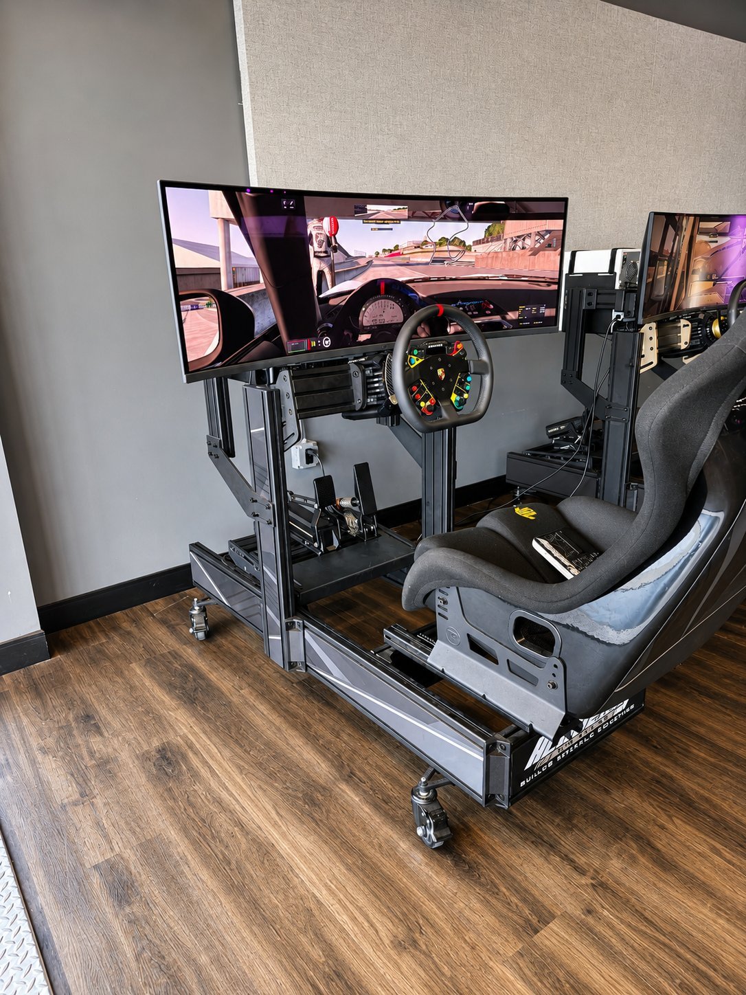 An Academy Club OLED custom sim racing build with a wide curved display